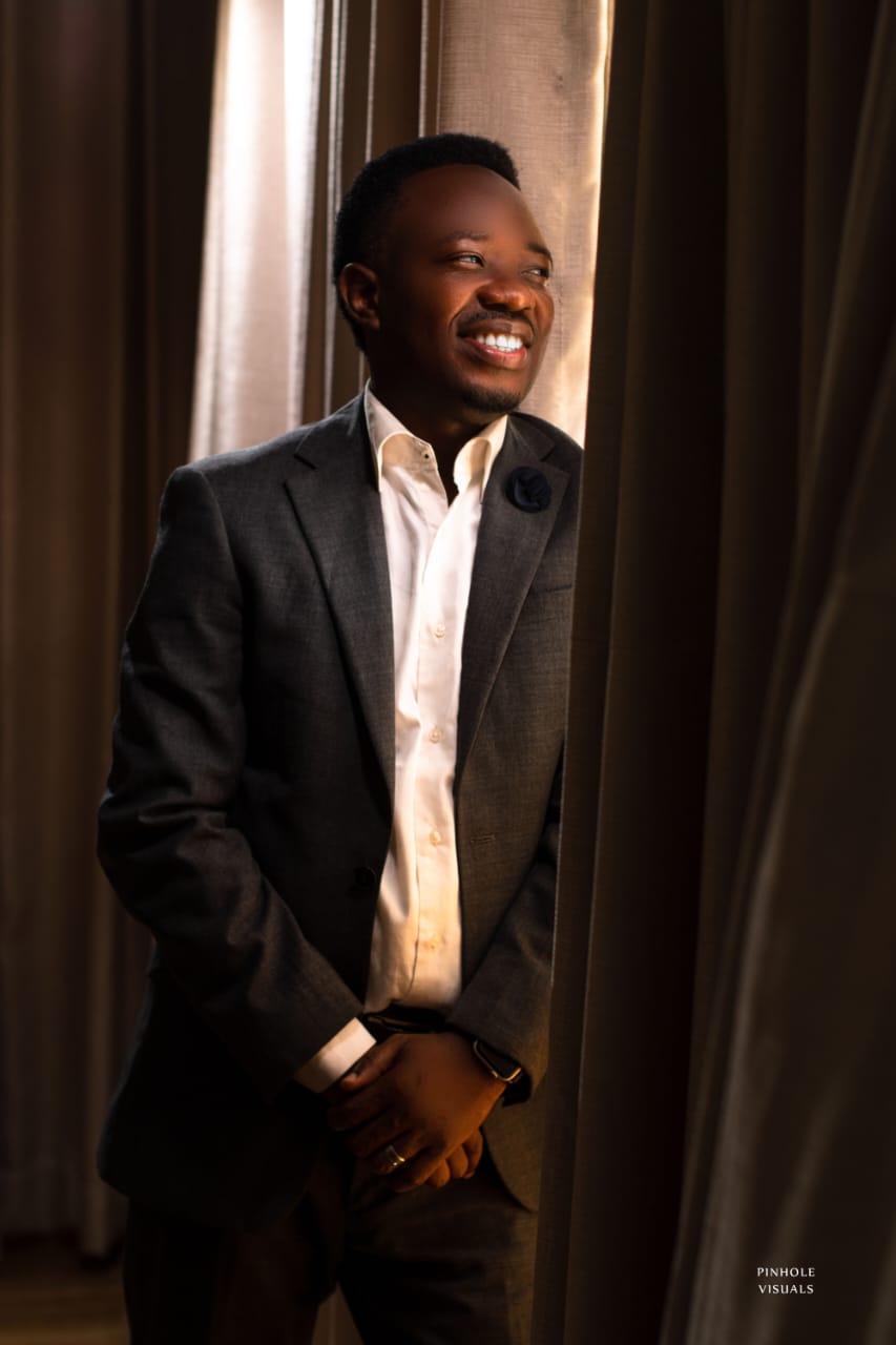 Pastor Cylars Omoloye smiling in a dark suit